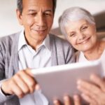 senior couple smile with tablet sofa online bingo crossword puzzle internet games living room elderly man woman with face happiness with technology web news home 590464 291840