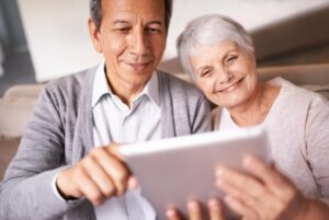 senior couple smile with tablet sofa online bingo crossword puzzle internet games living room elderly man woman with face happiness with technology web news home 590464 291840