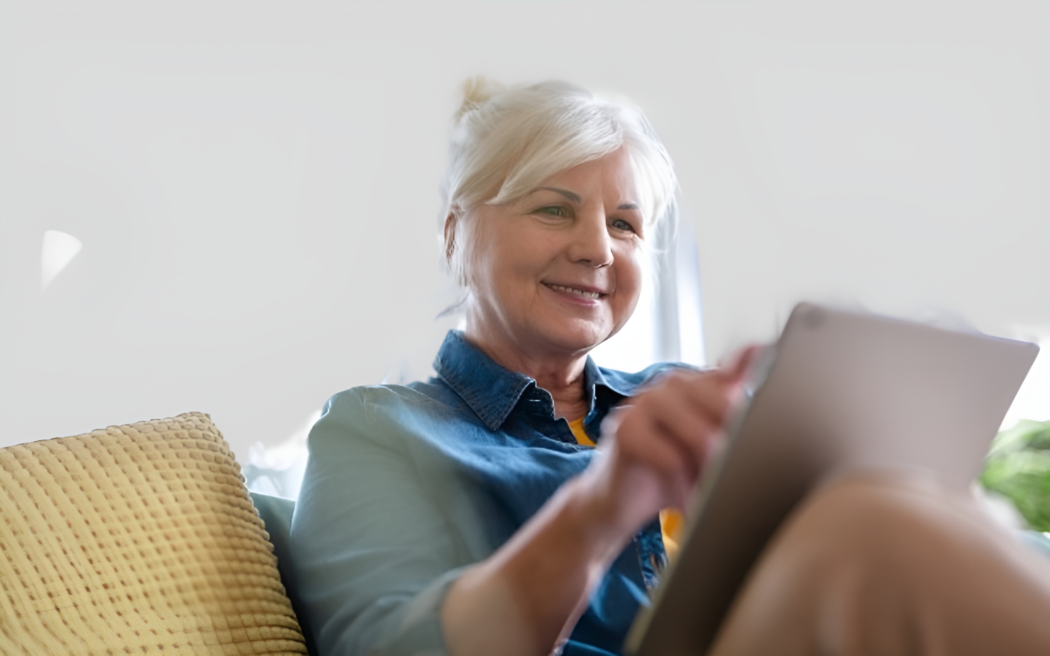 Smiling senior using laptop