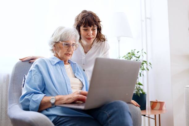 Elderly woman confused by laptop